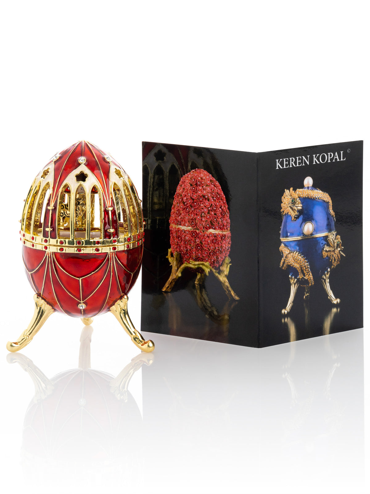 Oeuf de Fabergé rouge avec surprise de carrousel de chevaux à l'intérieur