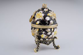 Oeuf de Fabergé noir décoré d'abeilles et de fleurs